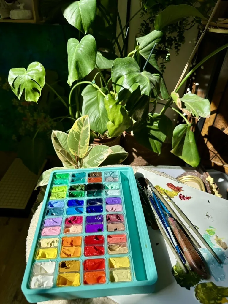 A palette of gouache among houseplants